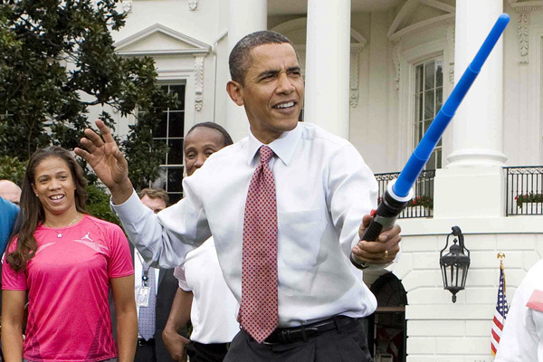 President Obama Holding a lightsaber